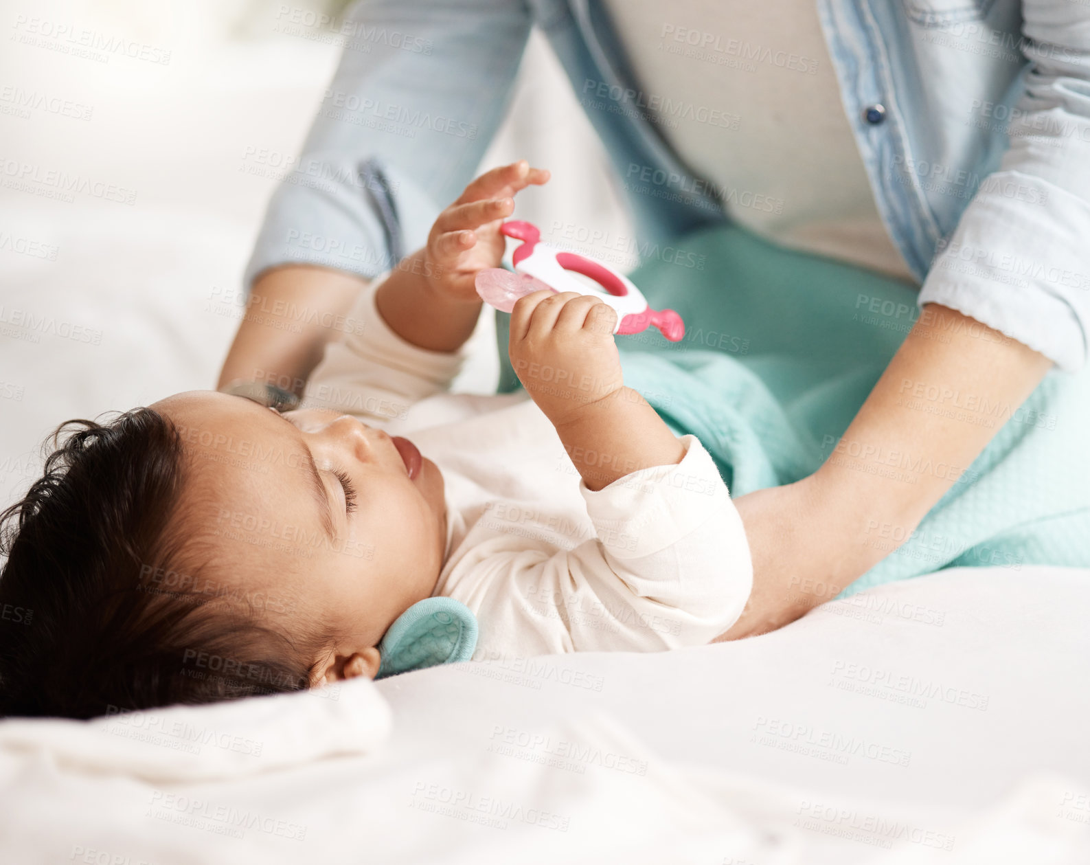 Buy stock photo Shot of an adorable little girl playing with a teething toy