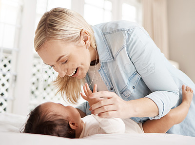 Buy stock photo Shot of a woman bonding with her baby at home