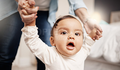 Buy stock photo Shot of a woman holding on to her baby's hands while she walks