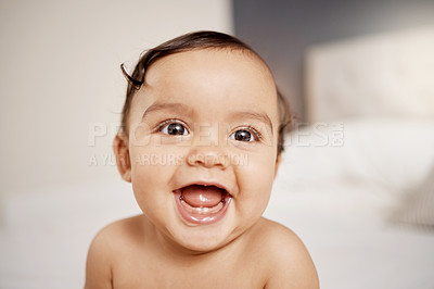 Buy stock photo Shot of an adorable baby girl sitting on a bed