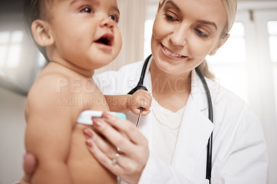 Buy stock photo Shot of a paediatrician taking a baby's temperature with a thermometer