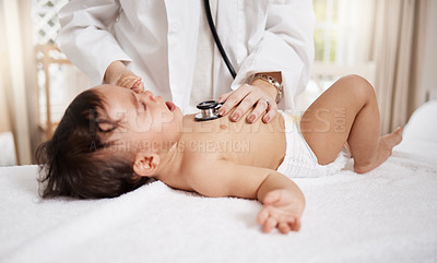 Buy stock photo Shot of a paediatrician using a stethoscope during a baby's checkup