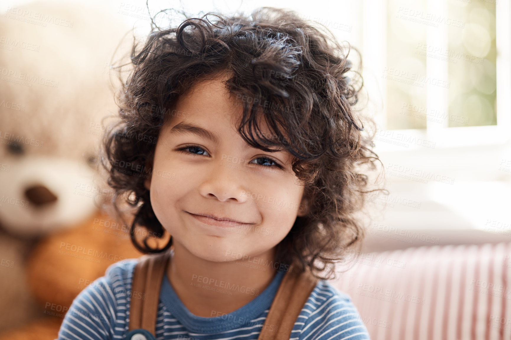 Buy stock photo Kid, portrait and boy in bedroom with smile in home, break and resting for childhood development. Male child, calm and relax in apartment, daylight and wellness with growth on weekend in house