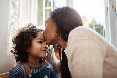 Buy stock photo Shot of a young woman spending quality time with her adorable child at home