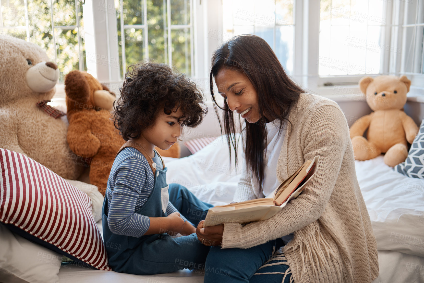 Buy stock photo Shot of a young woman spending quality time with her adorable child at home