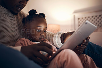 Buy stock photo Shot of a father reading his daughter bedtime stories