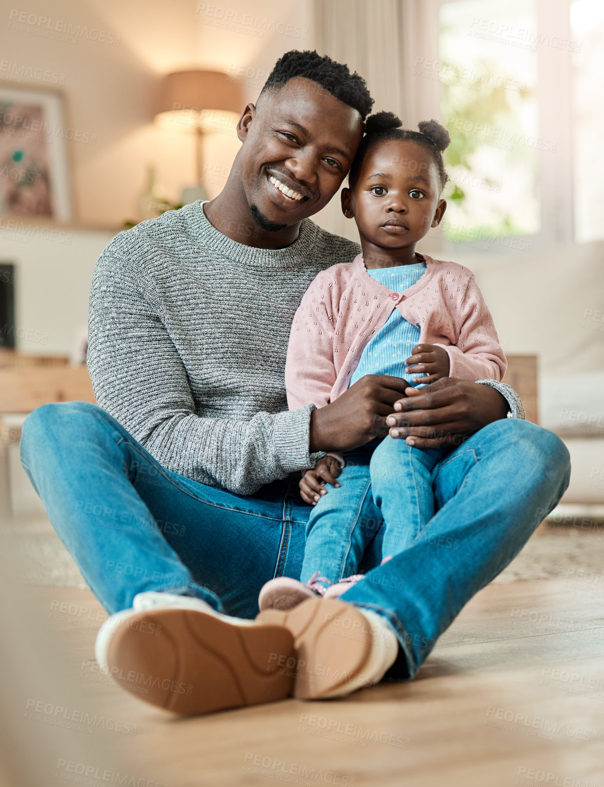 Buy stock photo Full length portrait of a handsome young man and his adorable little daughter sitting on the living room at home