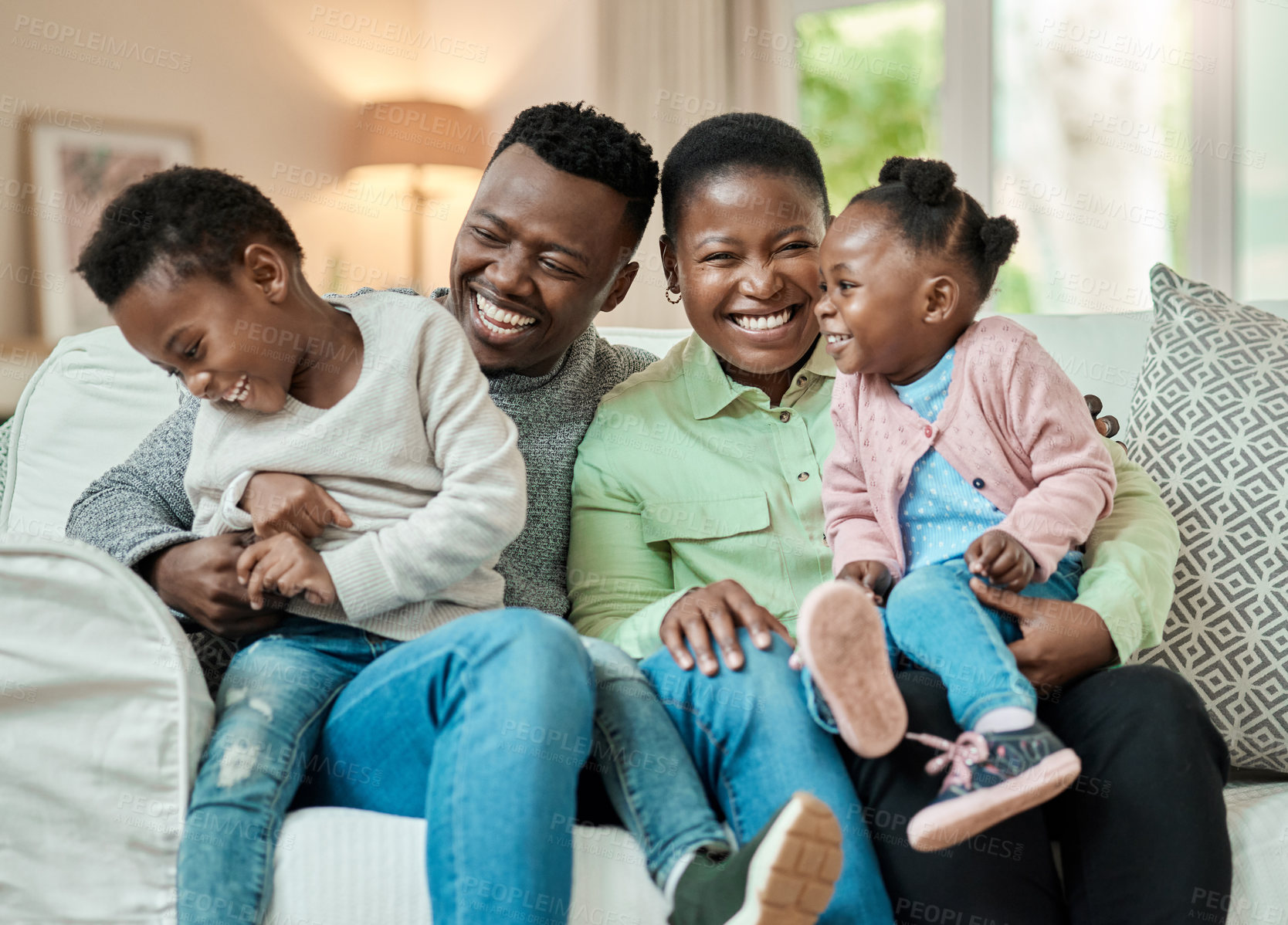 Buy stock photo Laugh, parents or children on couch with hug, childcare or bonding in healthy relationship. Happy, love or black family in house with embrace, fun together or connection for childhood development.