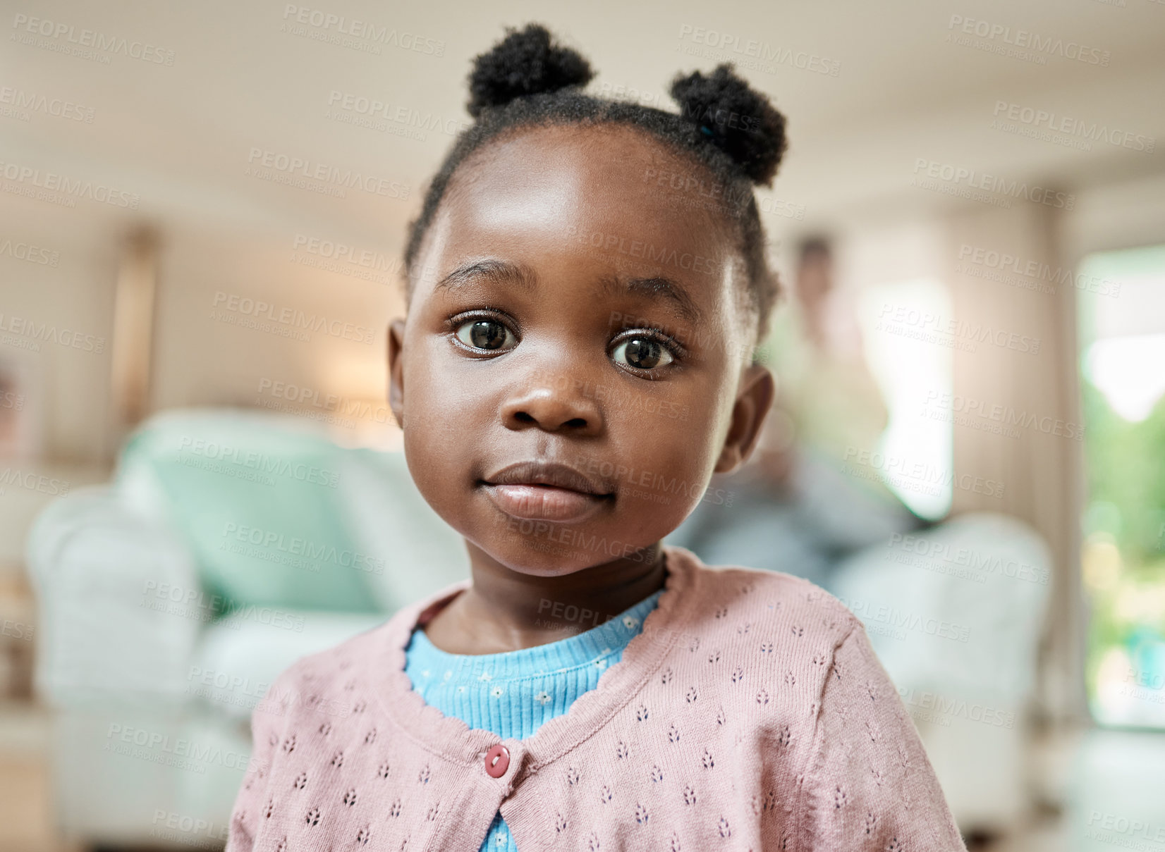 Buy stock photo Cropped portrait of an adorable little girl with pigtails sitting on the living room floor at home