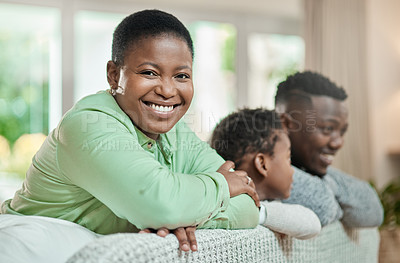 Buy stock photo Cropped portrait of an attractive young woman relaxing on a sofa in the living room with her husband and son