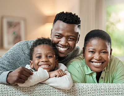 Buy stock photo Cropped portrait of an affectionate young family of three relaxing on the sofa in their living room at home