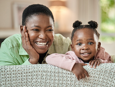 Buy stock photo Cropped portrait of an adorable little girl and her mother relaxing on a sofa in their living room at home