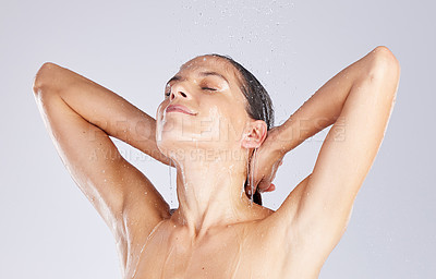 Buy stock photo Studio shot of an attractive young woman taking a shower against a grey background