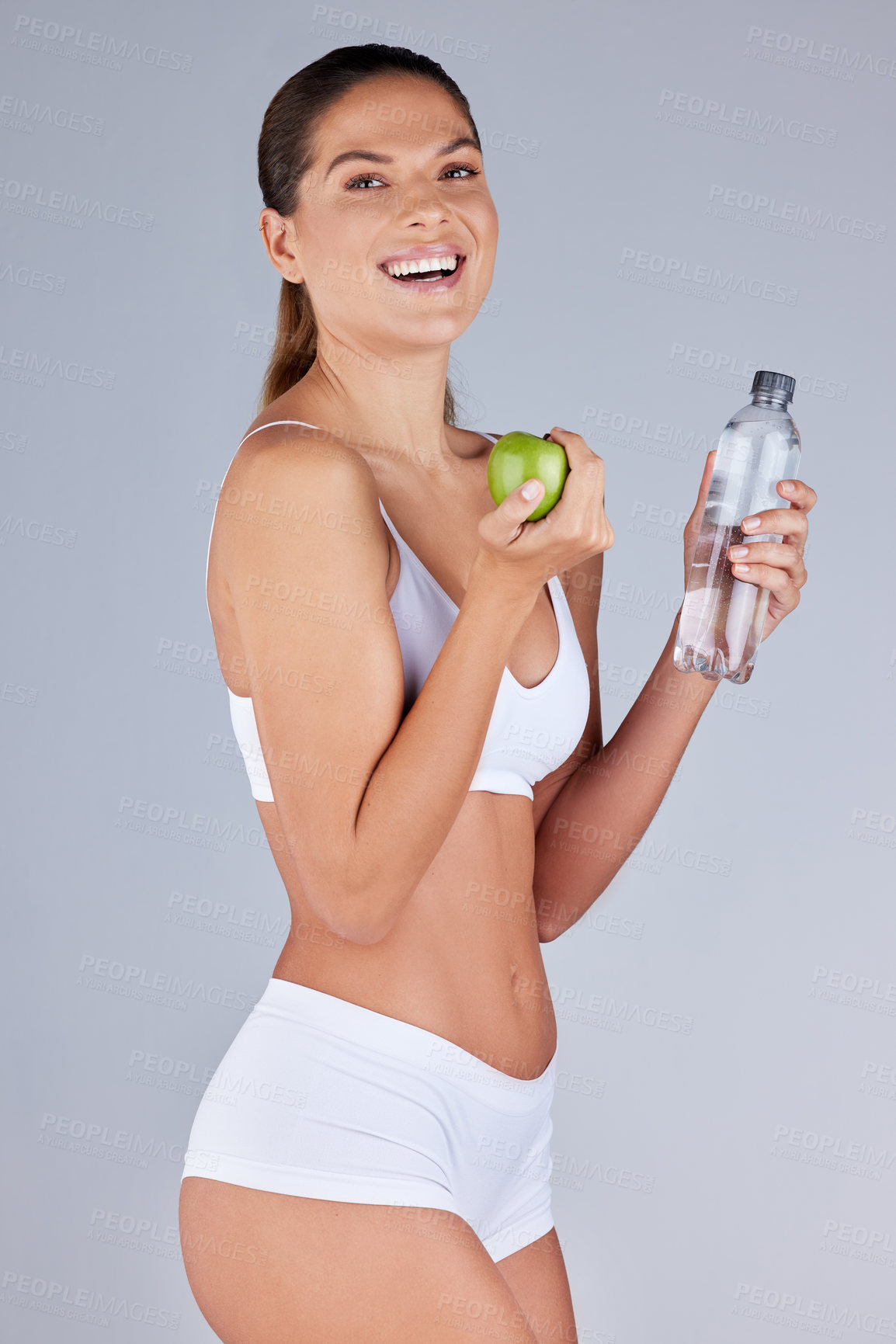 Buy stock photo Portrait, woman and apple with water for healthy diet, fitness and nutrition in grey studio background. Wellness, female person and fruit happy with drink for organic meal, snack or vegan eating