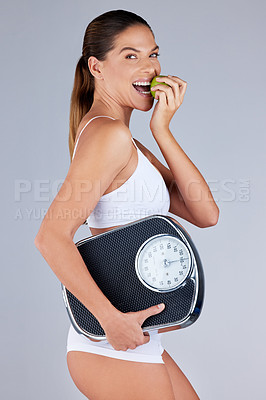 Buy stock photo Portrait, woman and apple with scale for healthy diet, fitness and weight loss in grey studio background. Wellness, female person and fruit happy for organic meal, snack or vegan eating with vitamins