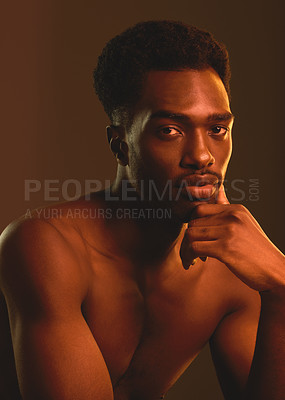 Buy stock photo Shot of a handsome young man posing in the studio