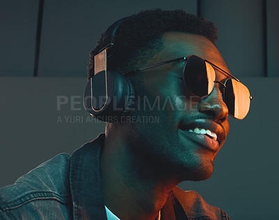 Buy stock photo Studio shot of a man wearing headphones and sunglasses