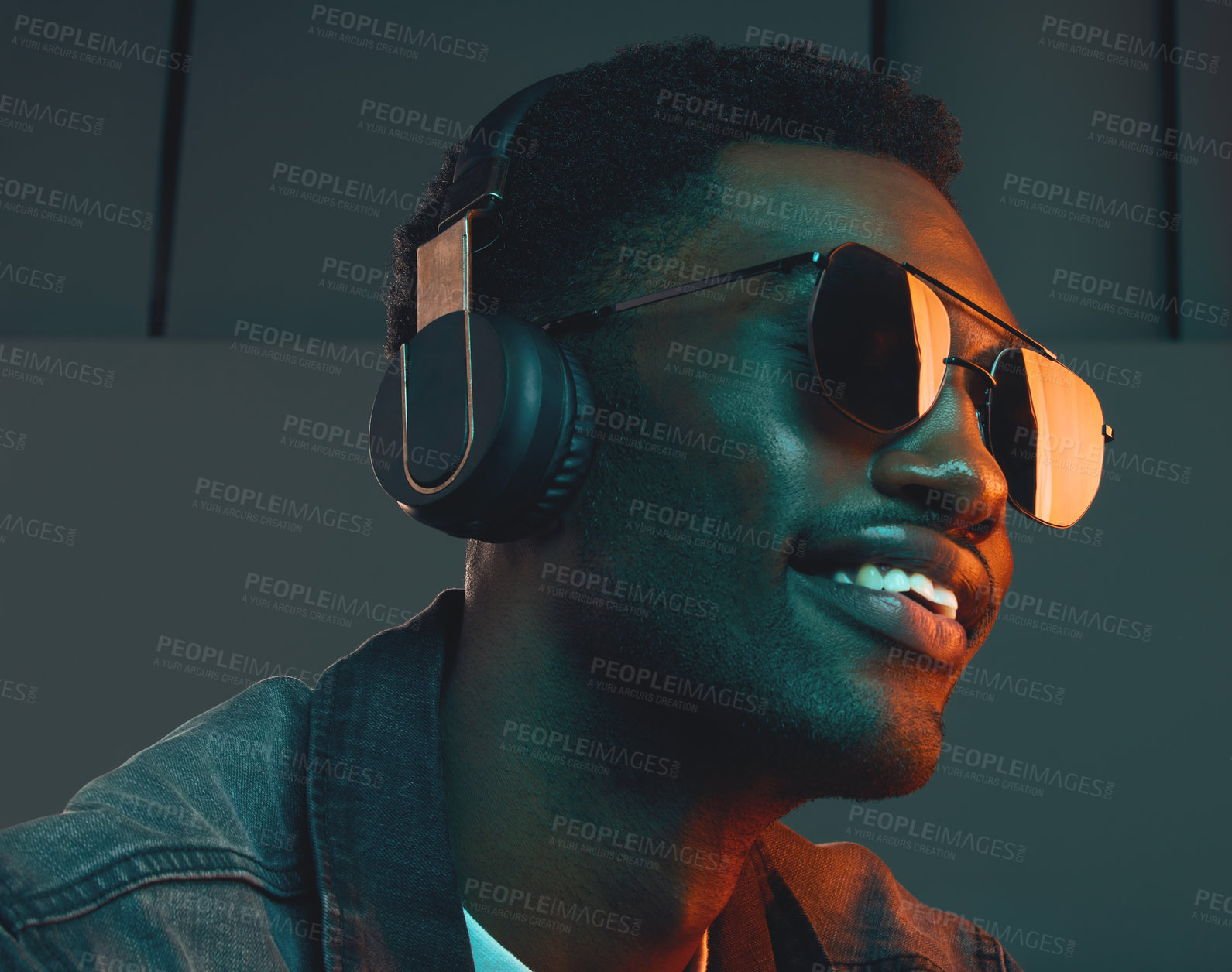 Buy stock photo Studio shot of a man wearing headphones and sunglasses