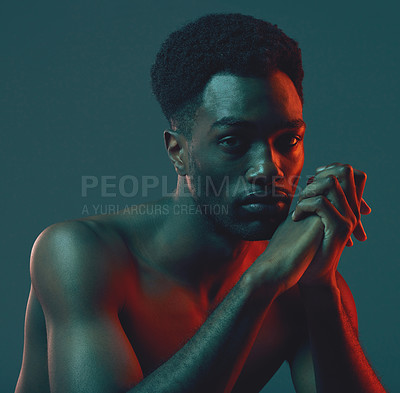 Buy stock photo Shot of a handsome young man posing in the studio