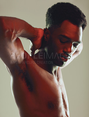 Buy stock photo Shot of a handsome young man posing in the studio