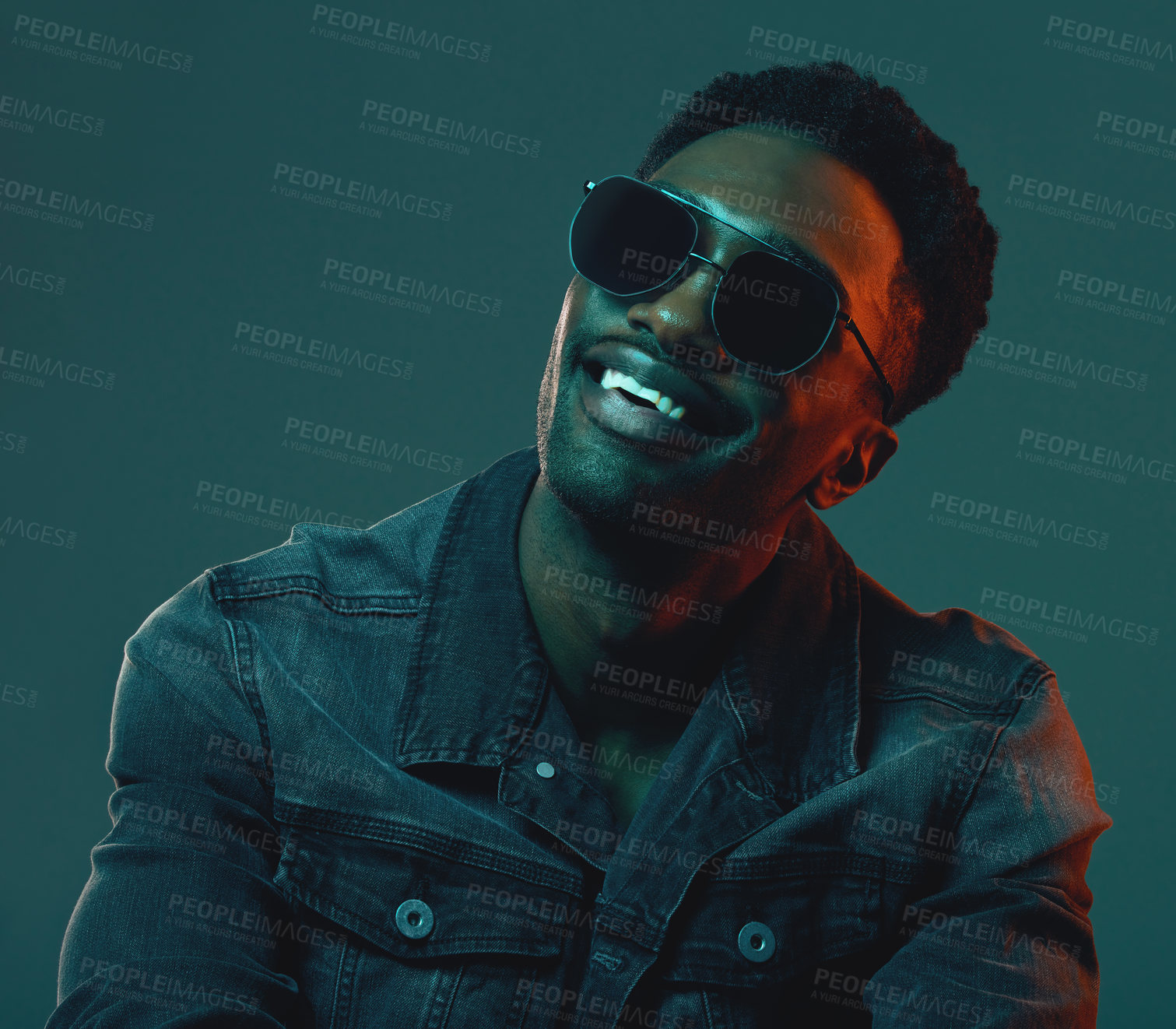 Buy stock photo Sunglasses, black man and fashion model in studio on dark background with confidence or denim jacket. Face, happy or handsome African male person with trendy clothes, smile or edgy style in Kenya