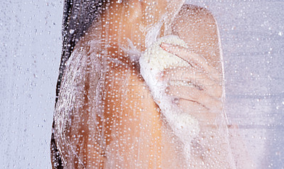 Buy stock photo Studio shot of a unrecognisable woman taking a shower against a grey background