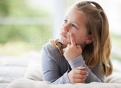 Buy stock photo Shot of a young girl relaxing in her bedroom daydreaming