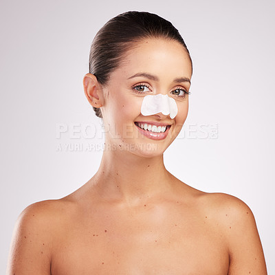 Buy stock photo Shot of an attractive young woman wearing blackhead remover against a studio background
