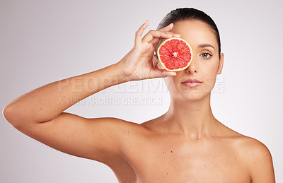 Buy stock photo Grapefruit, portrait and hand of woman with skincare in studio for organic facial, treatment or natural cosmetics on white background. Spa, fruit and model for vitamin C, dermatology or wellness