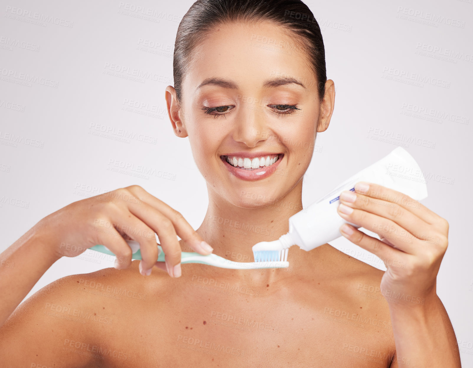 Buy stock photo Woman, toothpaste and brushing teeth for hygiene in studio with whitening results and oral health. Female person, dental product and brush with cleaning mouth for fresh breath by white background