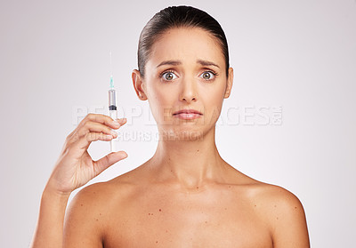 Buy stock photo Skincare, woman portrait and scared with syringe in studio for facelift, cosmetology or treatment on white background. Filler, body and hand of model for anti aging with anxiety for injection