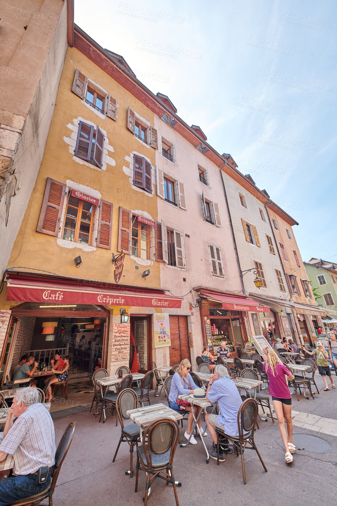 Buy stock photo Building, travel and people at restaurant at market for holiday, tourism and travellers abroad. Experience, vacation and tourists at outdoor cafe for exploring, relax or break in city in France