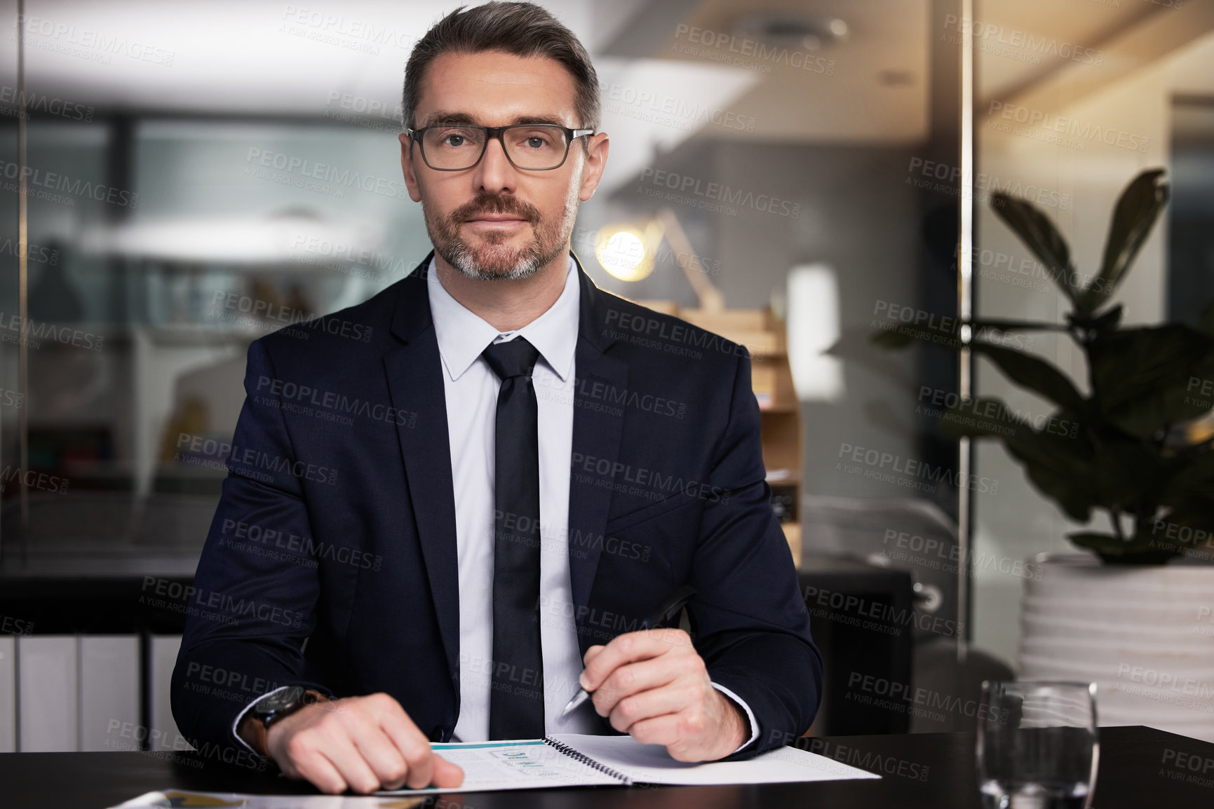 Buy stock photo Portrait of a mature businessman sitting at his desk