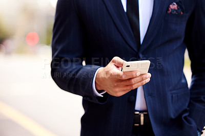 Buy stock photo Shot of a businessman using his smartphone to send a text message