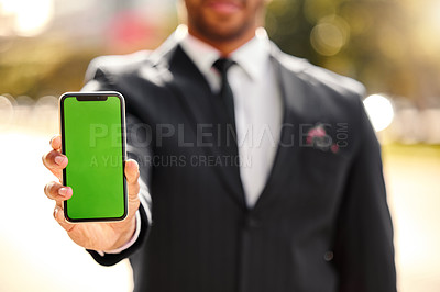 Buy stock photo Shot of a businessman holding his smartphone