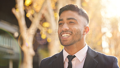 Buy stock photo Shot of a young businessman walking outside