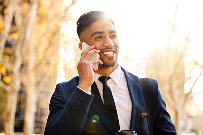 Buy stock photo Shot of a young businessman using his smartphone to make a phone call