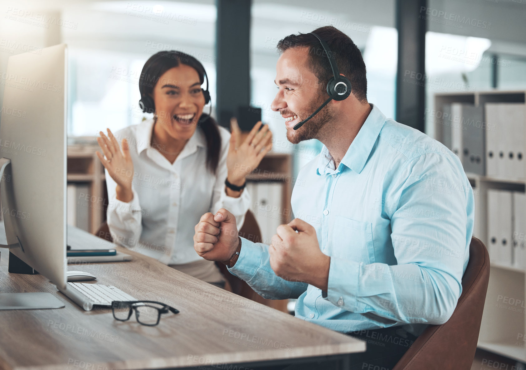Buy stock photo Celebration, call center and man with coworker in office for success, achievement or sales target. Happy, lens flare and telemarketing agent with headset for winning, consulting goal or CRM support