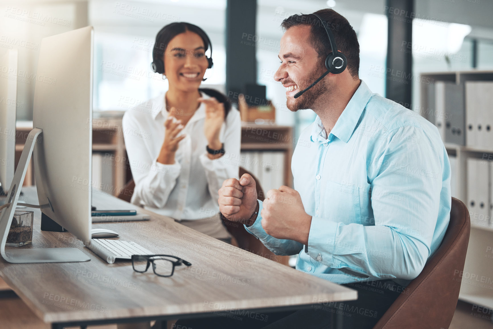 Buy stock photo Celebration, call center and man with colleague in office for success, achievement or sales target. Happy, lens flare and telemarketing agent with headset for winning, consulting goal or CRM support