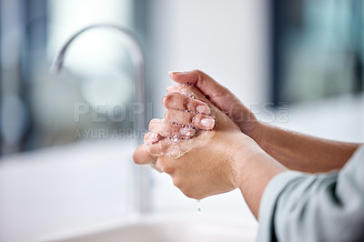 Buy stock photo Shot of a woman washing her hands in the sink