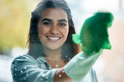 Buy stock photo Housekeeping, portrait and cleaner cleaning the window with a cloth by her home or apartment. Female maid, housekeeper or wife washing the glass door with detergent product for bacteria, dirt or dust