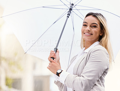 Buy stock photo Cropped portrait of an attractive young businesswoman walking through the city with an umbrella