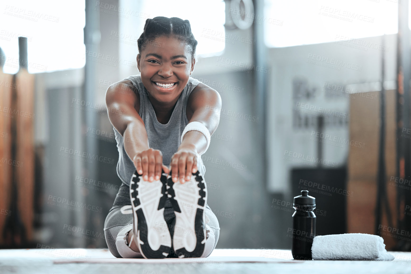Buy stock photo Portrait of a young beautiful woman doing stretches and exercising at the gym