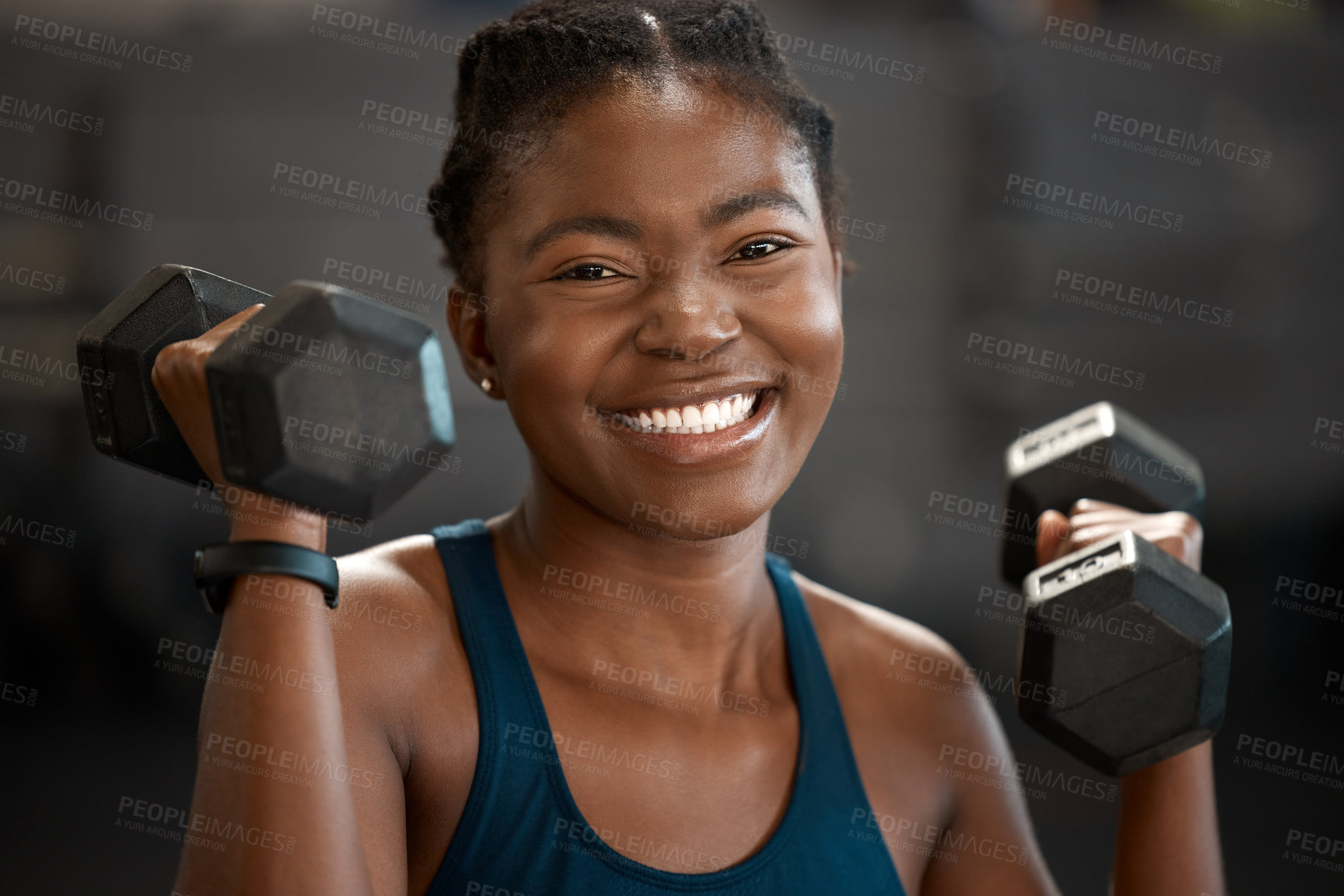 Buy stock photo Cropped portrait of an attractive and athletic young woman working out with dumbbells in the gym
