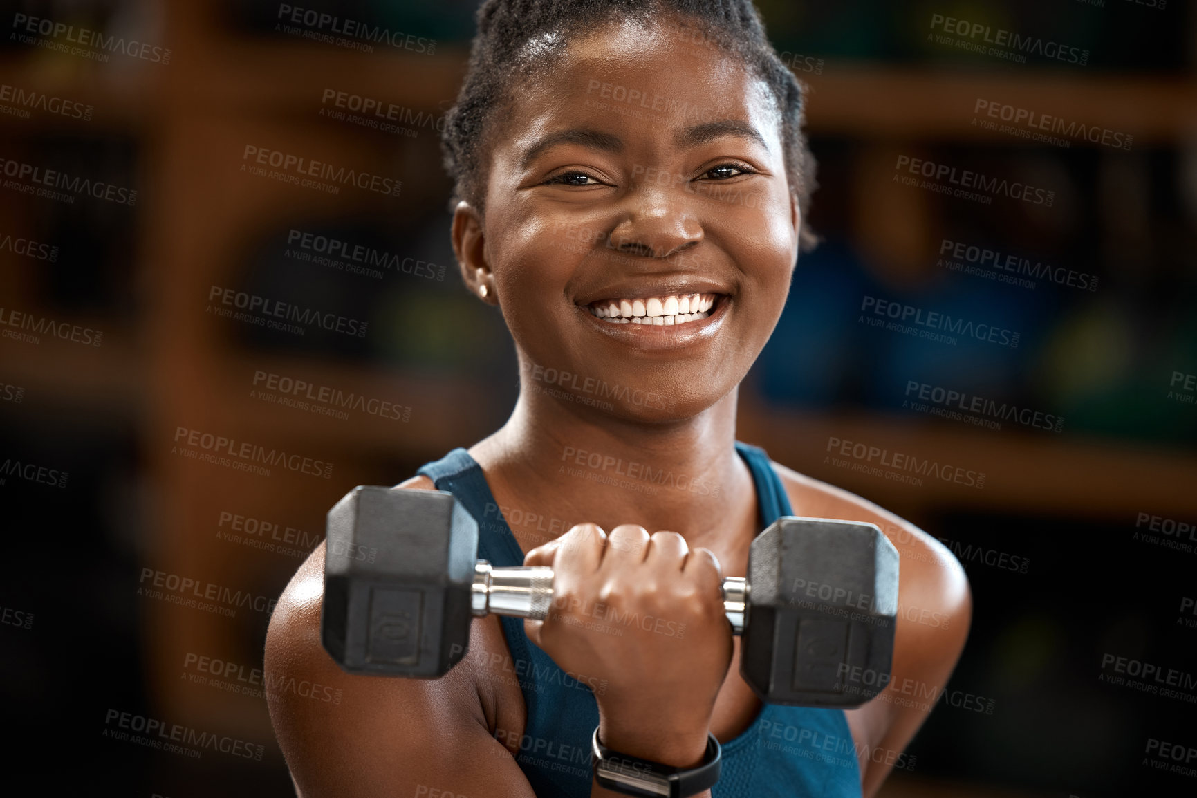Buy stock photo Cropped portrait of an attractive and athletic young woman working out with a dumbbell in the gym