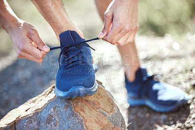 Buy stock photo Man, hands and tie shoes for running, fitness or getting ready for workout, hiking or walk in nature. Hand of male person, hiker or runner tying shoe for trekking, run or cardio exercise outdoors