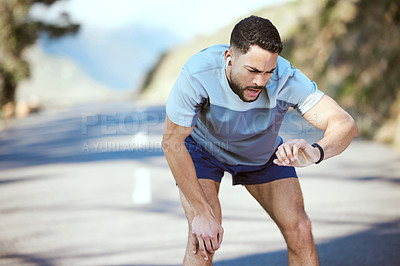 Buy stock photo Man, fitness and outdoor with a watch for a run or exercise with performance progress. Tired athlete person or runner on a road with time and music for training, running or health and wellness goals