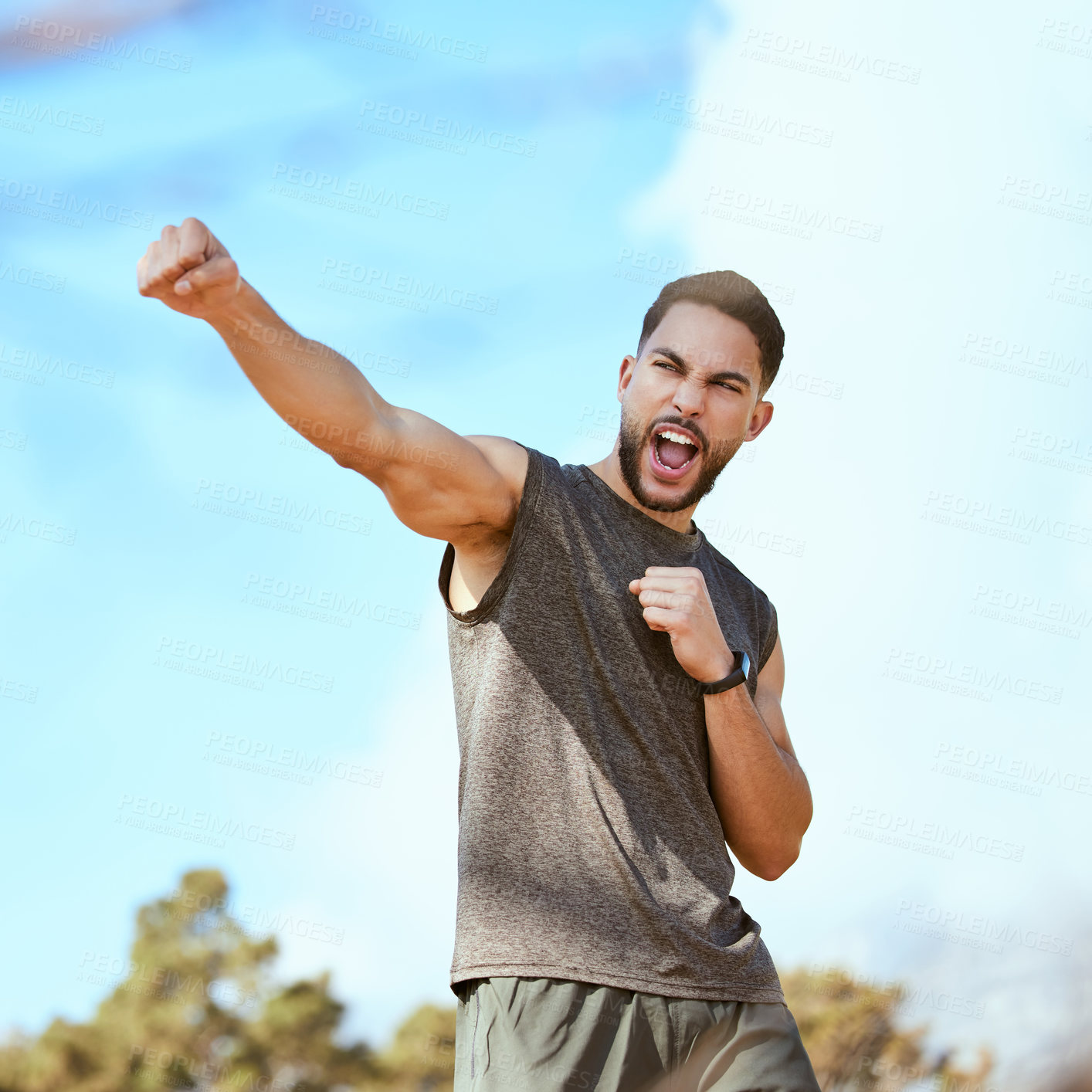 Buy stock photo Air, punch and man with fist in air for achievement in fitness outdoor for exercise in park. Summer, workout and energy for winning with excellence or athlete fight for progress in training and goals