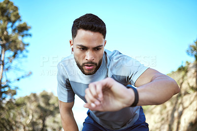 Buy stock photo Fitness watch, man and outdoor for a run or workout with earphones and app for progress. Tired male athlete person check time in nature forest for cardio training, running or health and wellness goal