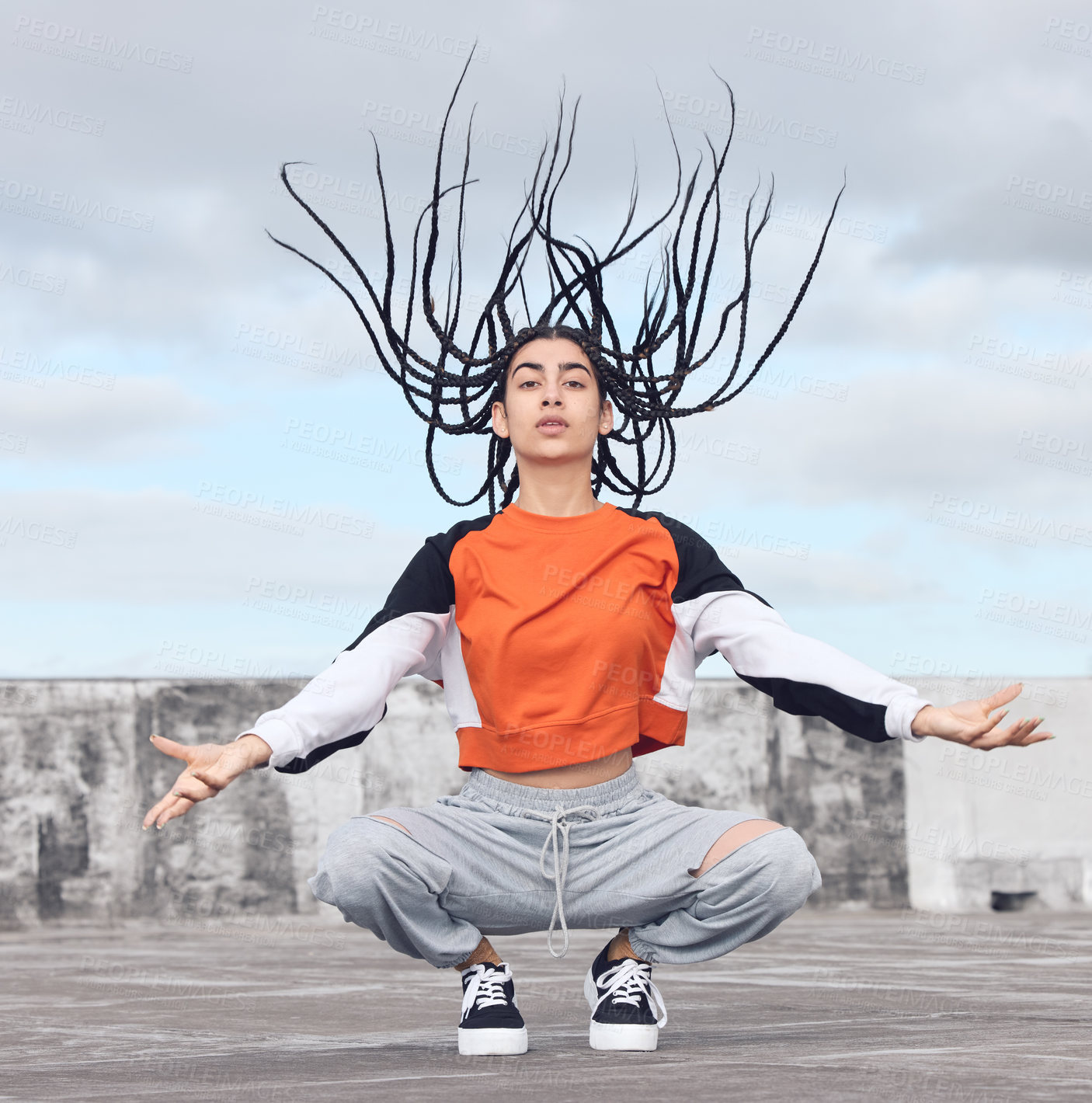 Buy stock photo Shot of a young woman out on a rooftop